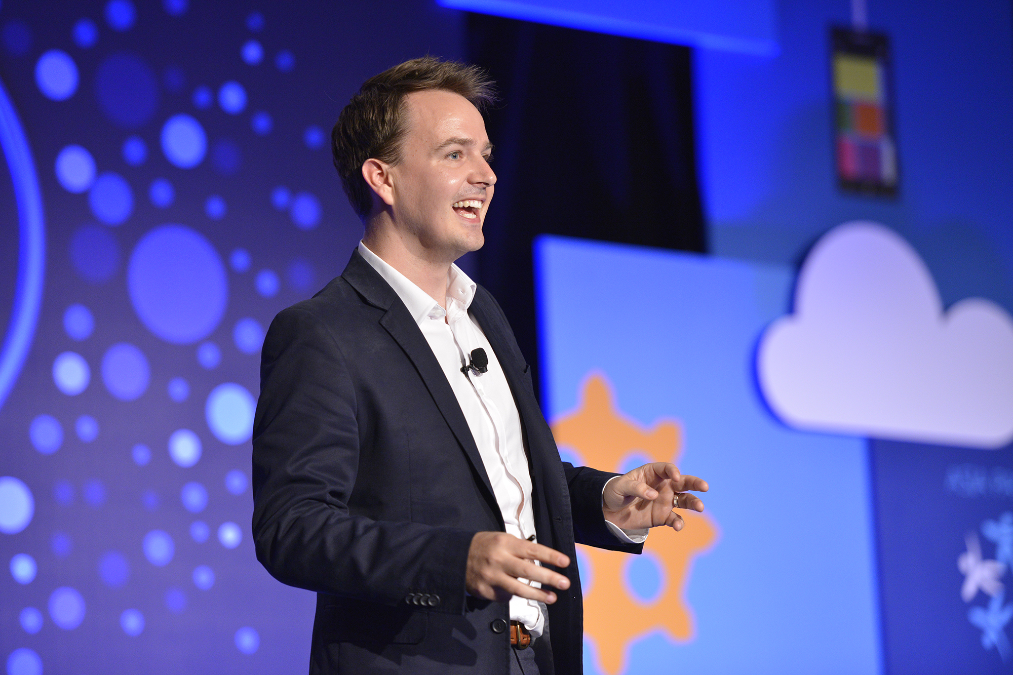 Shaun speaking on stage at a conference